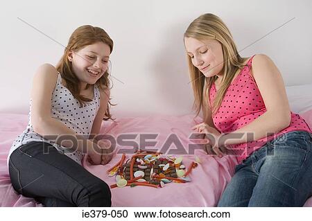 Teenage girls and a pile of sweets View Large Photo Image Stock Image - Teenage girls and a pile of sweets. Fotosearch