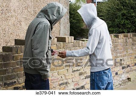Teenagers passing drugs View Large Photo Image Stock Image - Teenagers passing drugs. Fotosearch
