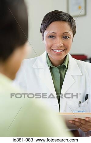 Stock Image - A doctor and a patient. Fotosearch