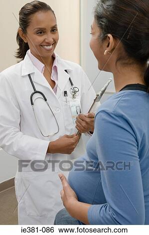 A doctor and a pregnant patient View Large Photo Image Stock Photograph - A doctor and a pregnant patient. Fotosearch