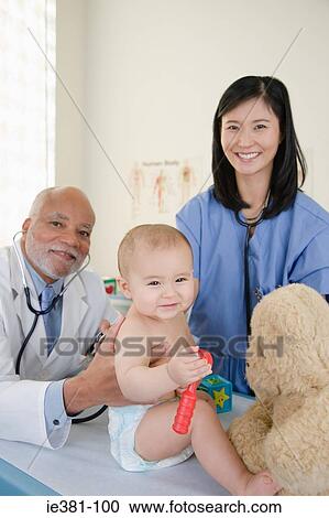 A doctor and nurse examining a baby View Large Photo Image Stock Image - A doctor and nurse examining a baby. Fotosearch