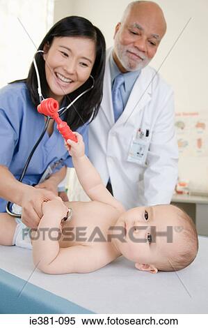 A doctor and nurse examining a baby View Large Photo Image Stock Photography - A doctor and nurse examining a baby. Fotosearch