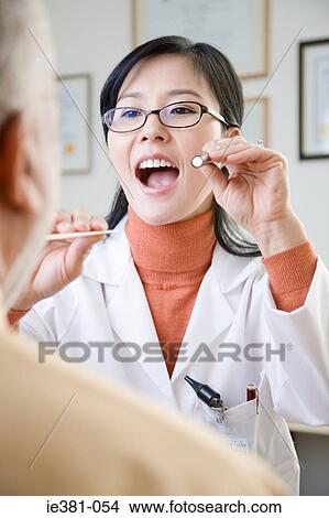 Picture - A doctor examining a patient. Fotosearch