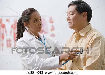 Stock Image - A doctor examining a patient. Fotosearch