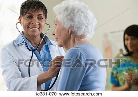 Stock Image - A doctor examining a patient. Fotosearch