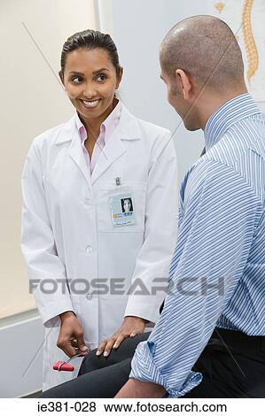 A doctor examining a patient View Large Photo Image Stock Photo - A doctor examining a patient. Fotosearch