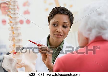 A doctor explaining to a patient View Large Photo Image Stock Image - A doctor explaining to a patient. Fotosearch