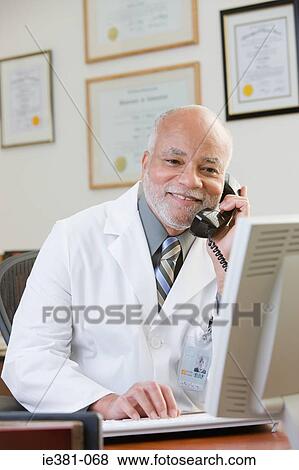 Stock Photo - A doctor using the phone. Fotosearch