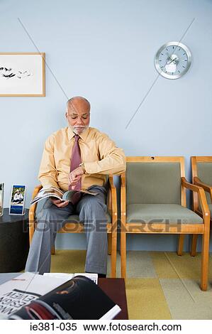 A man looking at his watch View Large Photo Image Stock Photography - A man looking at his watch. Fotosearch