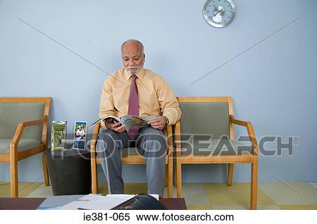 Stock Photography - A man reading a magazine. Fotosearch