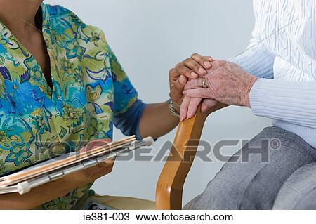 A nurse consoling a patient View Large Photo Image Stock Image - A nurse consoling a patient. Fotosearch