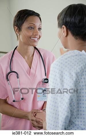 A nurse consoling a patient View Large Photo Image Stock Image - A nurse consoling a patient. Fotosearch