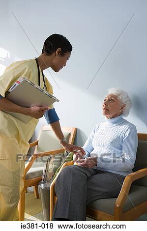 A nurse consoling a patient View Large Photo Image Stock Photo - A nurse consoling a patient. Fotosearch