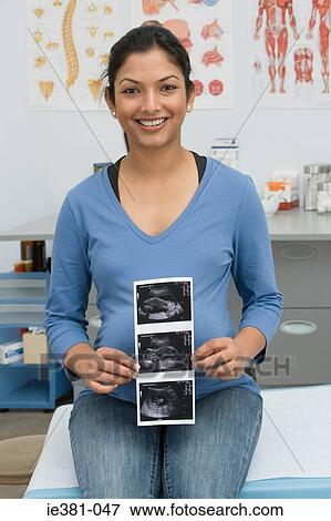 A pregnant woman holding a scan View Large Photo Image Stock Photo - A pregnant woman holding a scan. Fotosearch