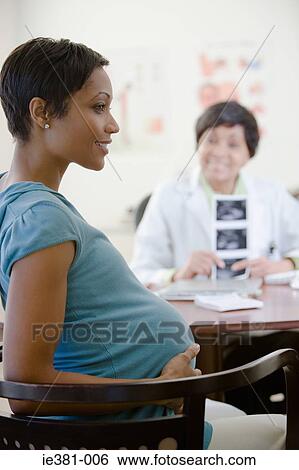 A pregnant woman in a doctors office View Large Photo Image Stock Photograph - A pregnant woman in a doctors office. Fotosearch