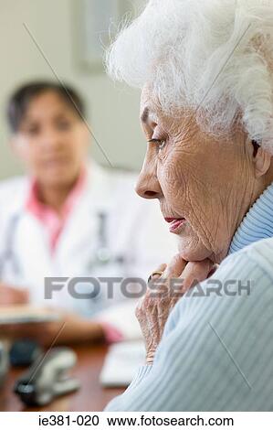 A worried woman at the doctors View Large Photo Image Stock Image - A worried woman at the doctors. Fotosearch