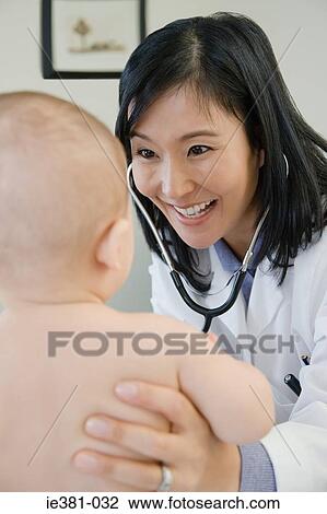 Doctor examining a baby View Large Photo Image Stock Image - Doctor examining a baby. Fotosearch