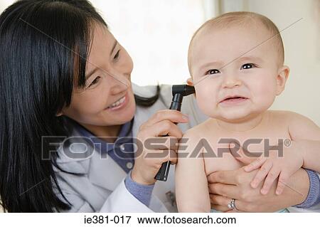 Doctor examining a baby View Large Photo Image Stock Photo - Doctor examining a baby. Fotosearch