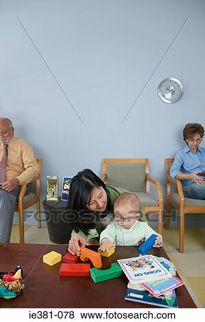Patients waiting in a doctors office View Large Photo Image Stock Photo - Patients waiting in a doctors office. Fotosearch