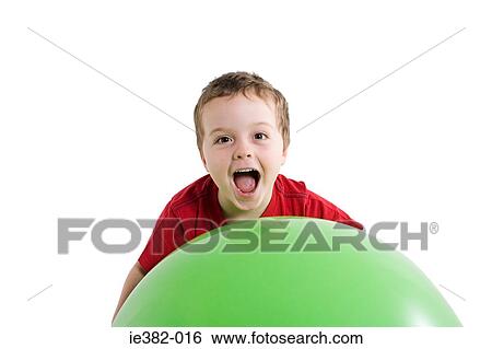 A boy holding a ball View Large Photo Image Stock Photograph - A boy holding a ball. Fotosearch
