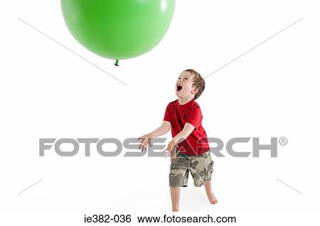 A boy playing with a balloon View Large Photo Image Stock Photograph - A boy playing with a balloon. Fotosearch