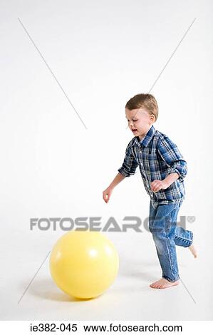 A boy running after a ball View Large Photo Image Stock Photography - A boy running after a ball. Fotosearch