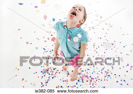 A girl playing in confetti View Large Photo Image Stock Photography - A girl playing in confetti. Fotosearch