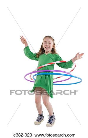 Stock Image - A girl playing with a plastic hoop. Fotosearch