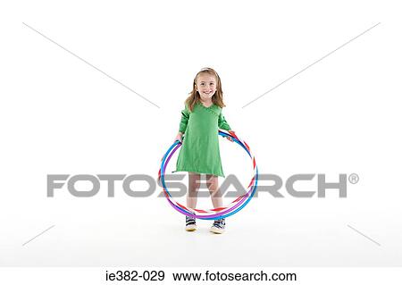 A girl playing with a plastic hoop View Large Photo Image Stock Photo - A girl playing with a plastic hoop. Fotosearch