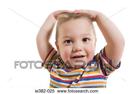 A toddler with his hands on his head View Large Photo Image Stock Photography - A toddler with his hands on his head. Fotosearch