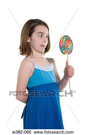 Stock Image - Girl holding a lollipop. Fotosearch