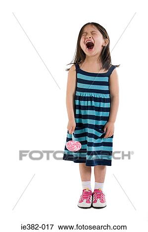 Girl shouting and holding a lollipop View Large Photo Image Stock Photo - Girl shouting and holding a lollipop. Fotosearch