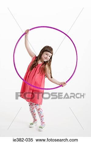 Portrait of a girl holding a plastic hoop View Large Photo Image Stock Photography - Portrait of a girl holding a plastic hoop. Fotosearch