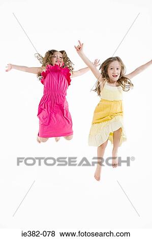 Two girls jumping View Large Photo Image Stock Photo - Two girls jumping. Fotosearch