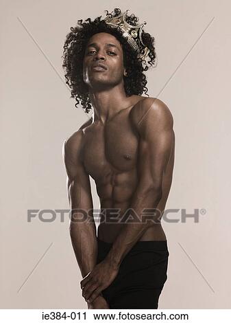 Stock Image - Young man wearing a crown. Fotosearch