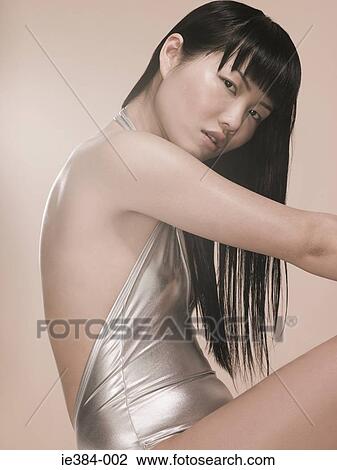 Young woman in silver outfit View Large Photo Image Stock Image - Young woman in silver outfit. Fotosearch