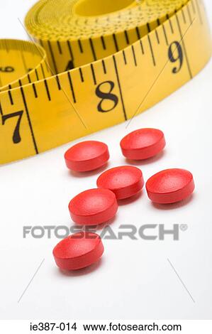 Tape measure and diet pills View Large Photo Image Picture - Tape measure and diet pills. Fotosearch
