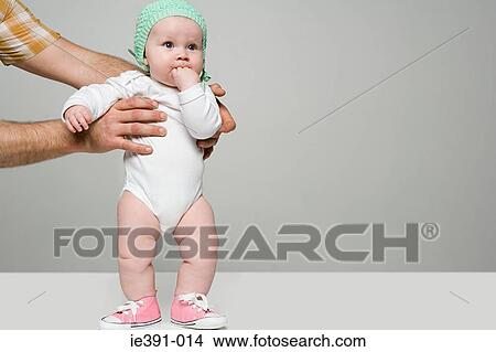 Picture - Adult holding baby. Fotosearch