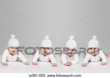 Stock Image - Babies in bobble hats. Fotosearch