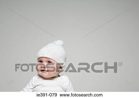 Stock Photo - Baby in a bobble hat. Fotosearch