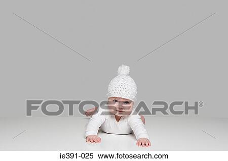 Stock Photography - Baby in a bobble hat. Fotosearch