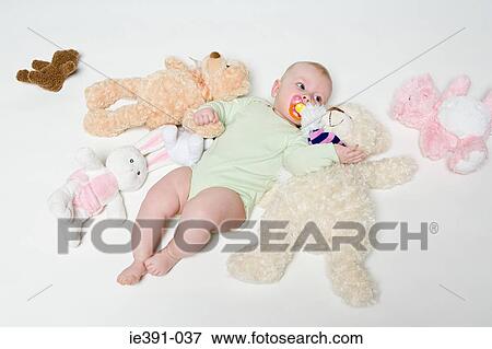 Baby with soft toys View Large Photo Image Stock Photo - Baby with soft toys. Fotosearch