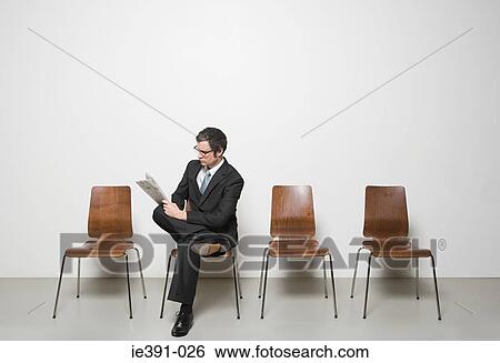 Businessman reading a newspaper View Large Photo Image Stock Photograph - Businessman reading a newspaper. Fotosearch