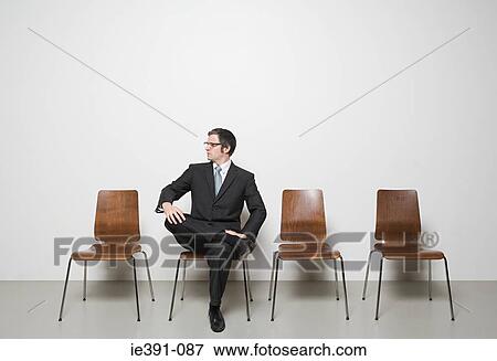 Stock Photo - Businessman sitting in chair. Fotosearch