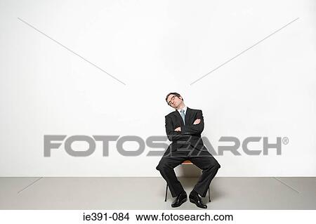 Picture - Businessman sleeping in chair. Fotosearch