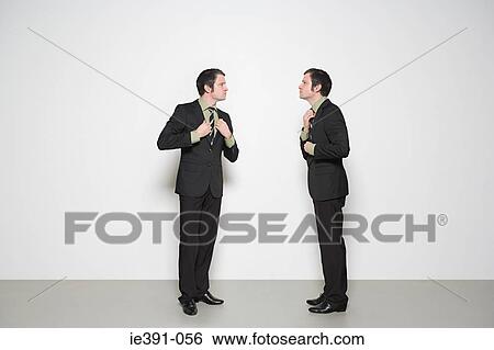 Businessmen adjusting clothes View Large Photo Image Stock Photograph - Businessmen adjusting clothes. Fotosearch