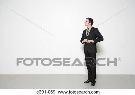 Stock Photo - Man buttoning jacket. Fotosearch