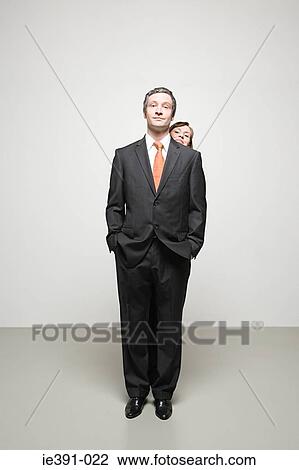 Woman looking over mans shoulder View Large Photo Image Stock Image - Woman looking over mans shoulder. Fotosearch