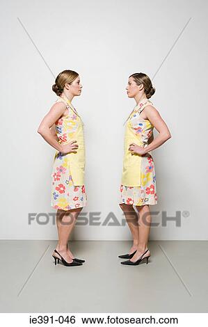 Women facing each other View Large Photo Image Stock Photograph - Women facing each other. Fotosearch