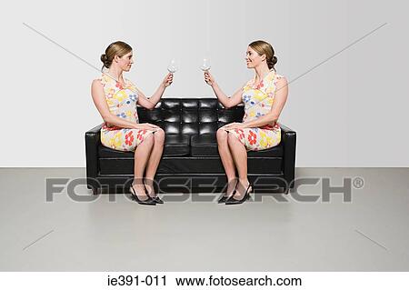 Stock Image - Women with wine glasses. Fotosearch